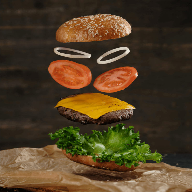 A beef burger exploded to show all its contents.