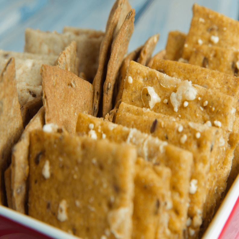 A container with lost of salted crisp biscuits.
